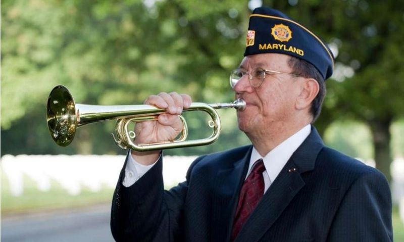 Legionnaire among thousands who play taps in a moment of remembrance