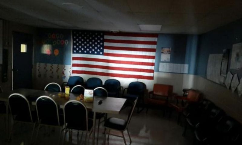 Flag illuminated in dark room