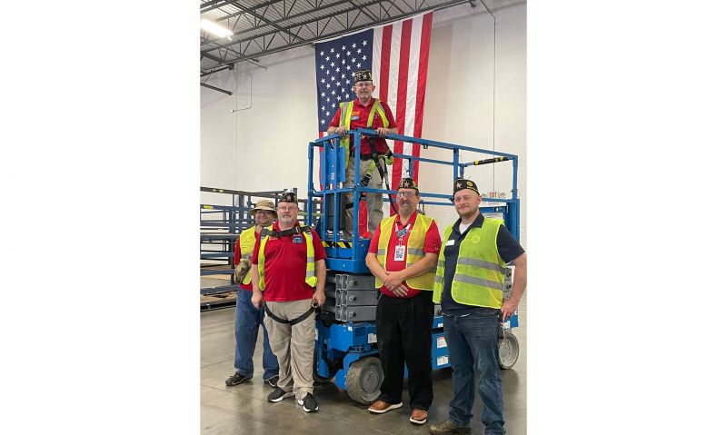 Texas Legionnaires raise American flag inside a Penske Logistics 